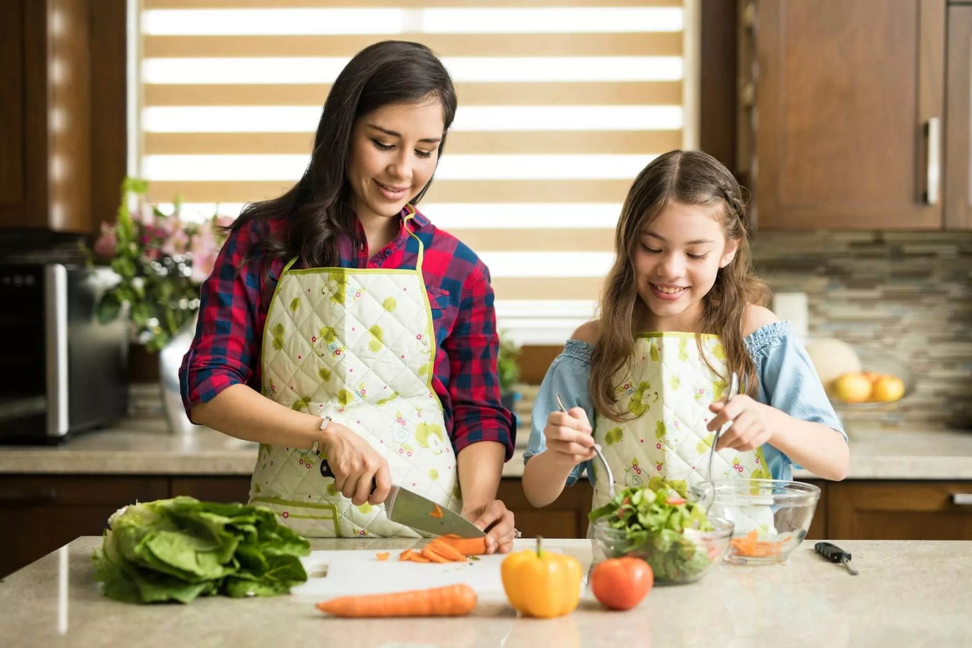 Mother making healthy salad with daughter jpg